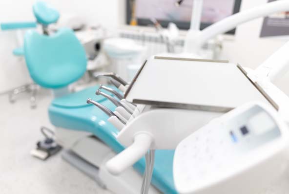 Dental chair with instrument tray ready for the next patient